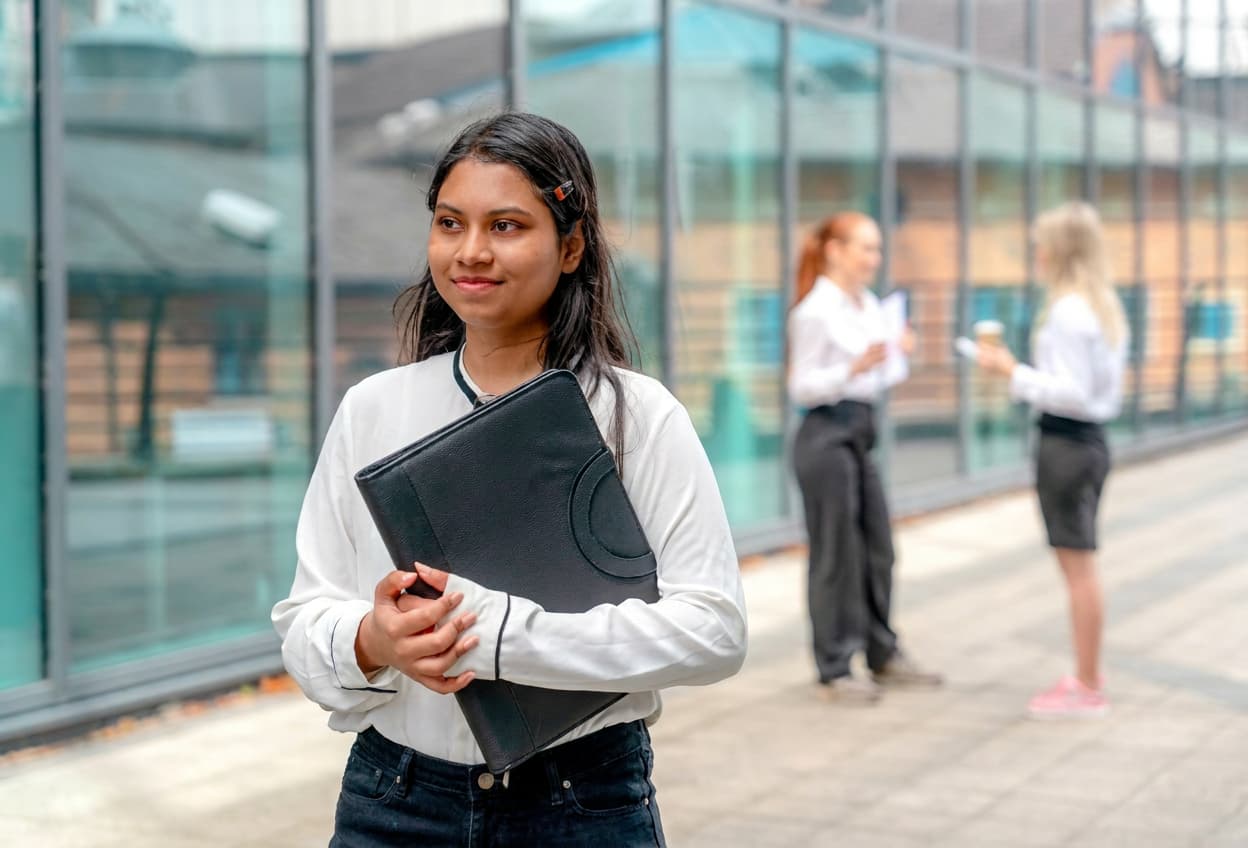 A younger student with a study abroad backpack ready to travel.