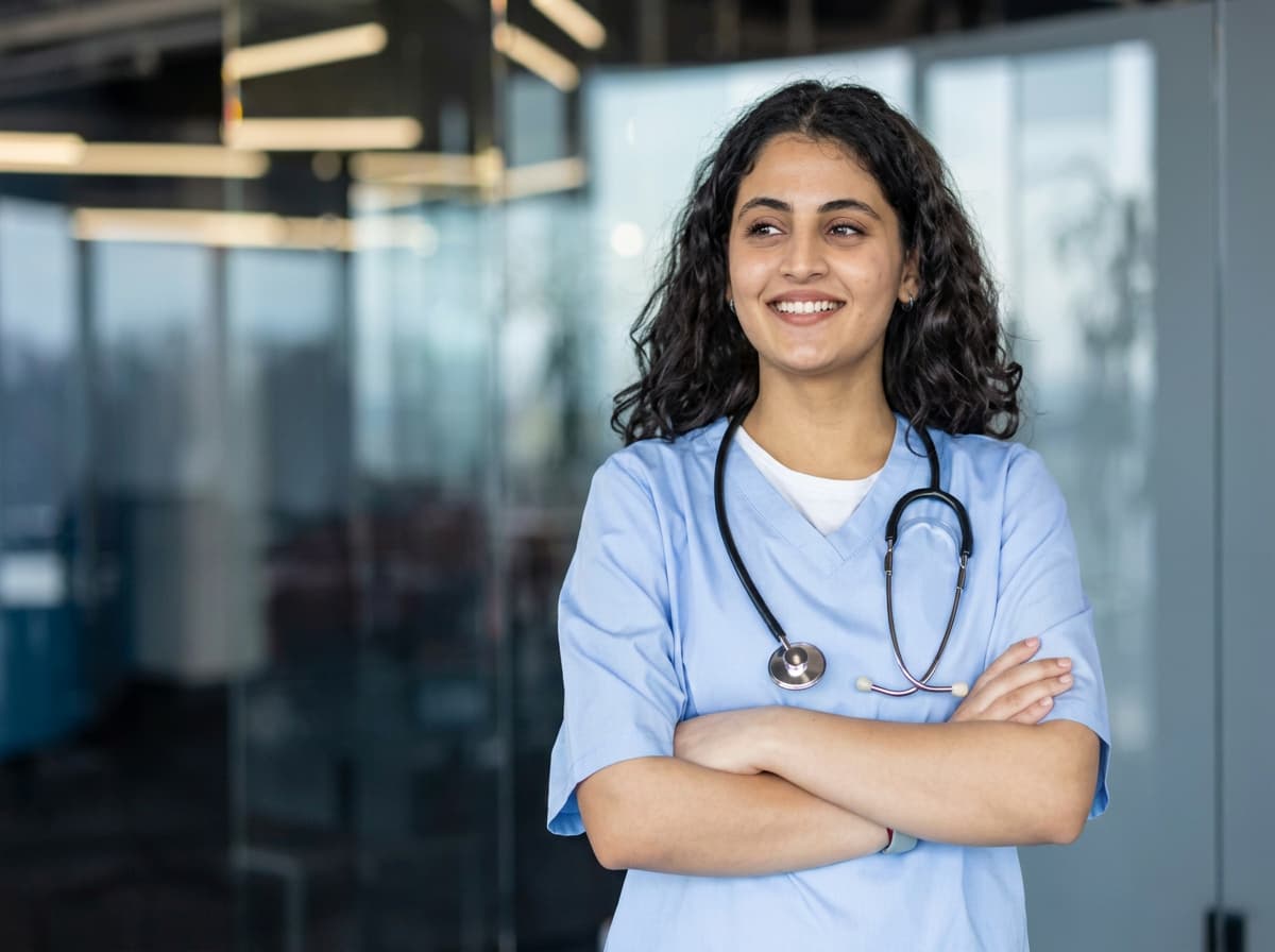 A clinician in scrubs with a stethoscope.