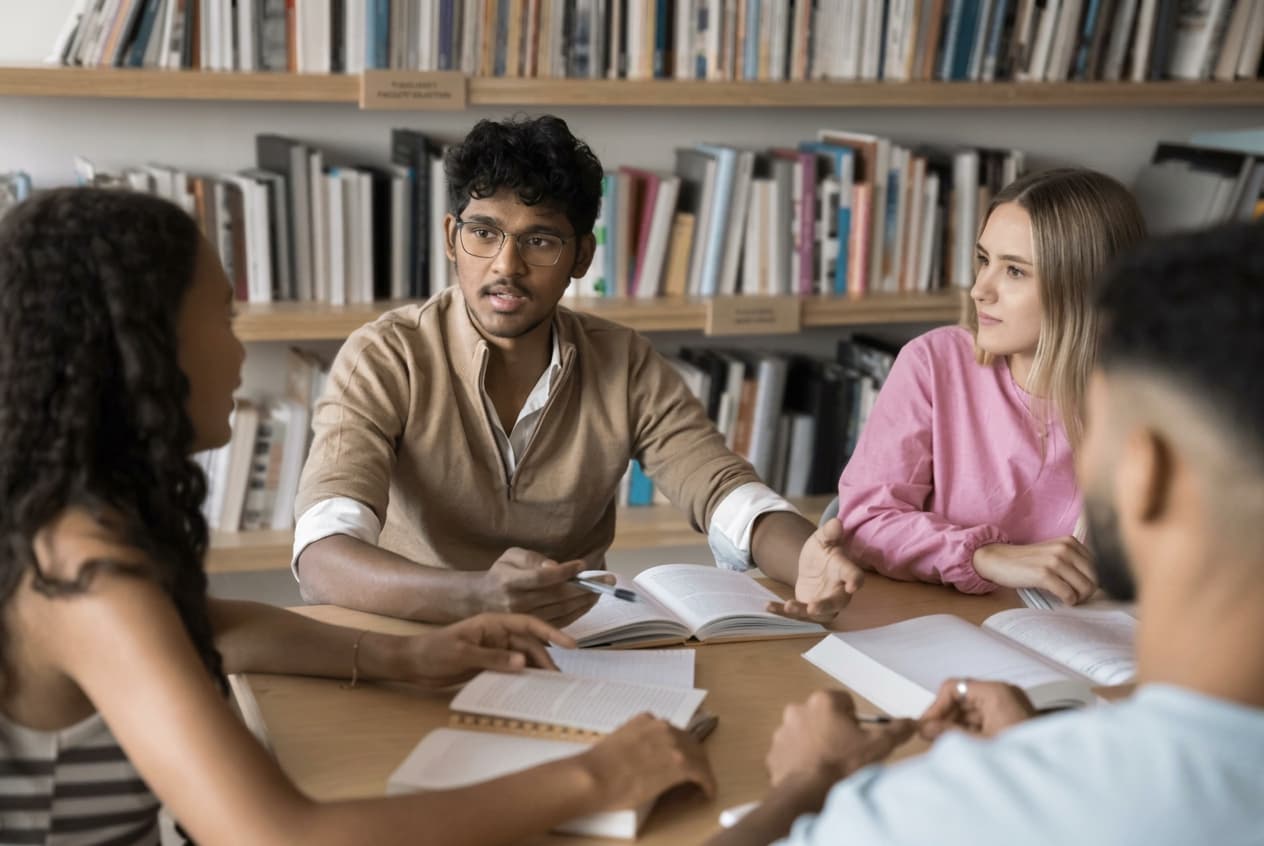 A study group working together at a library table.