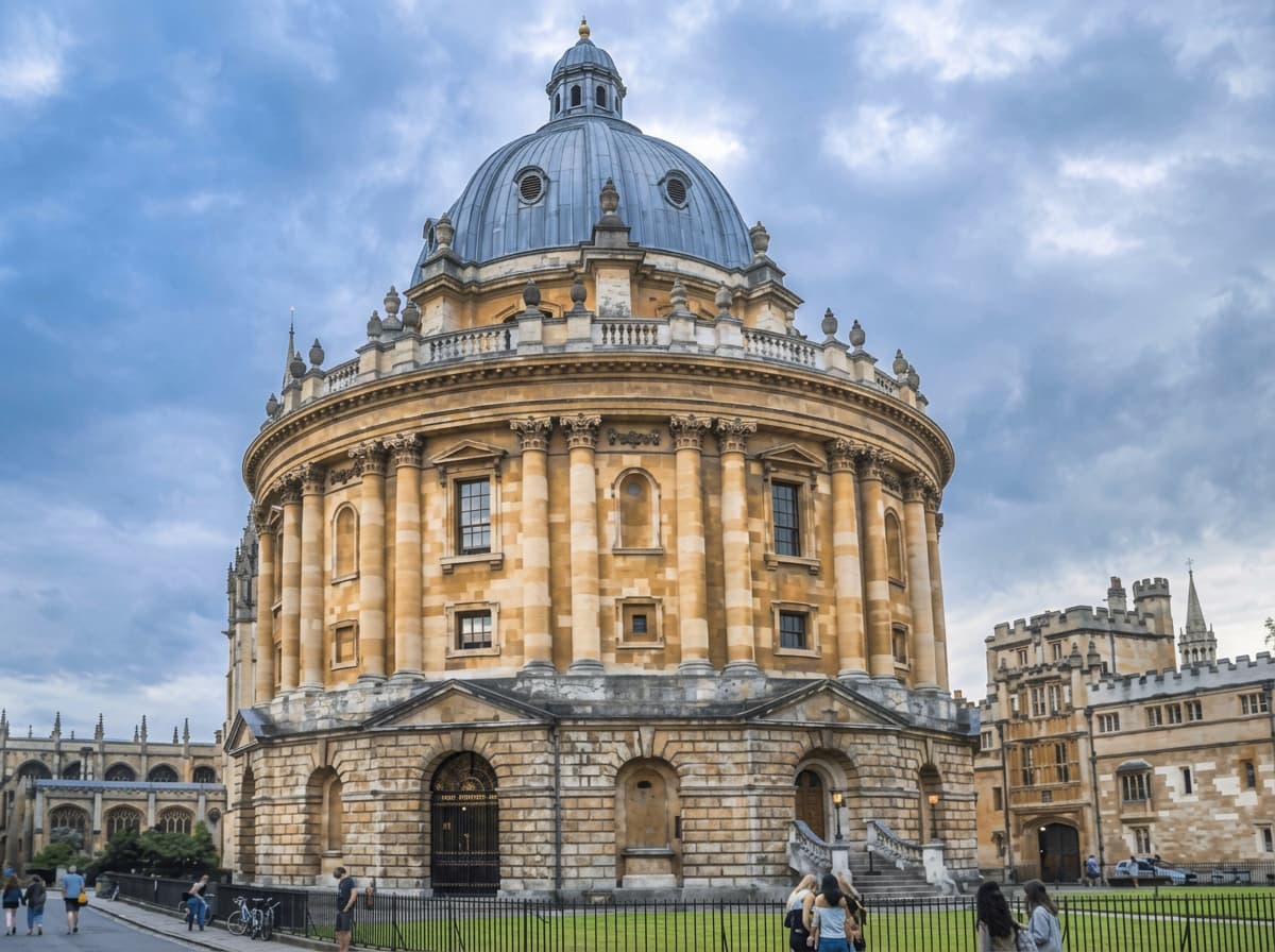 A domed honey-stone university library in Oxford under a heavy grey sky.