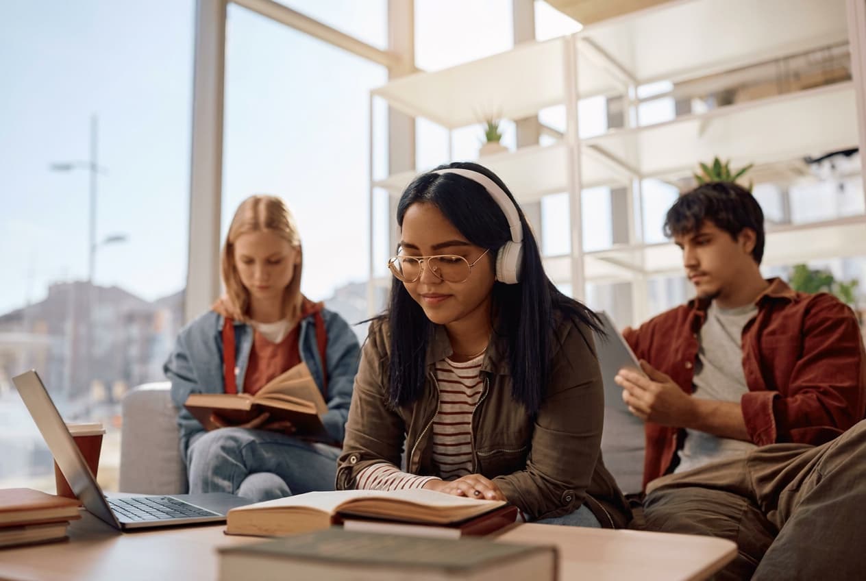 Students studying together on a lounge sofa.